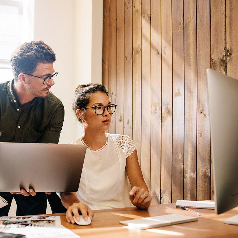 two colleagues looking at screen