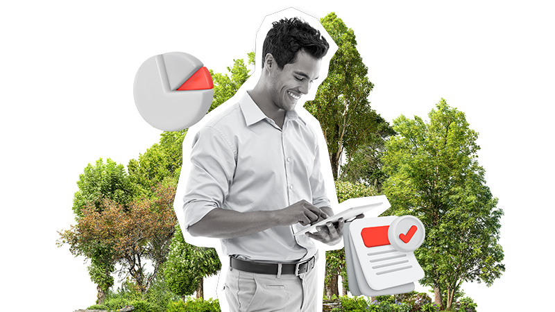 man on laptop in front of foliage