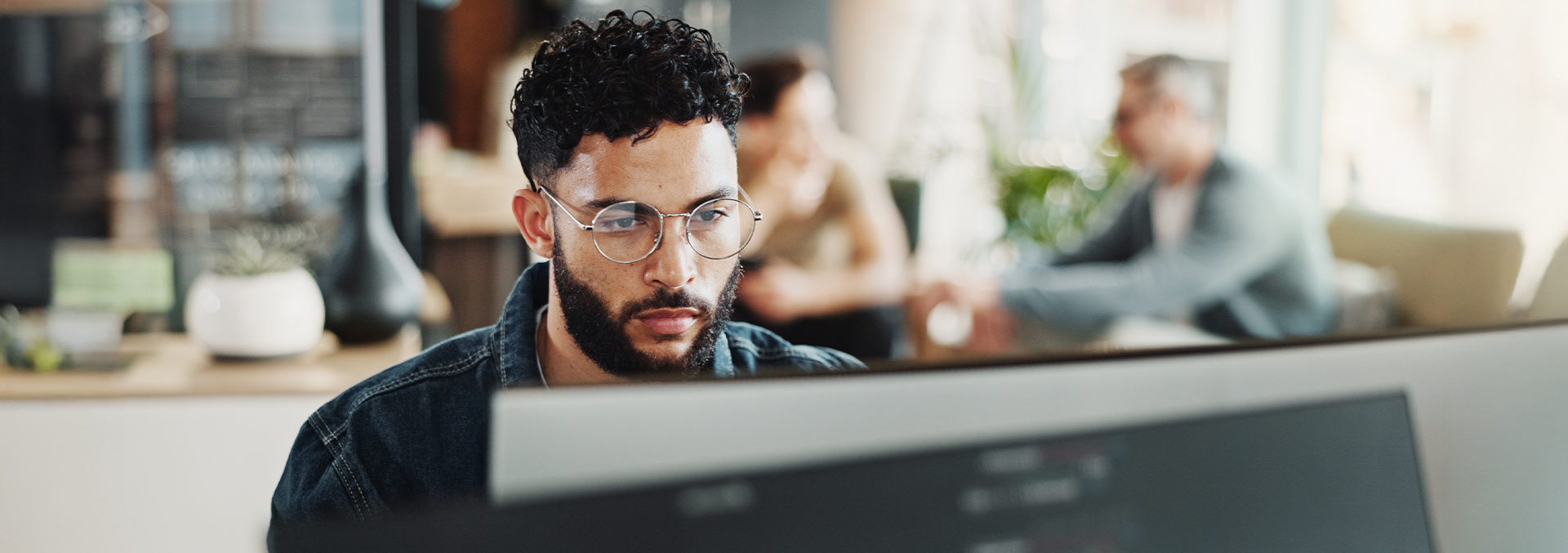 Person with glasses staring at Screen