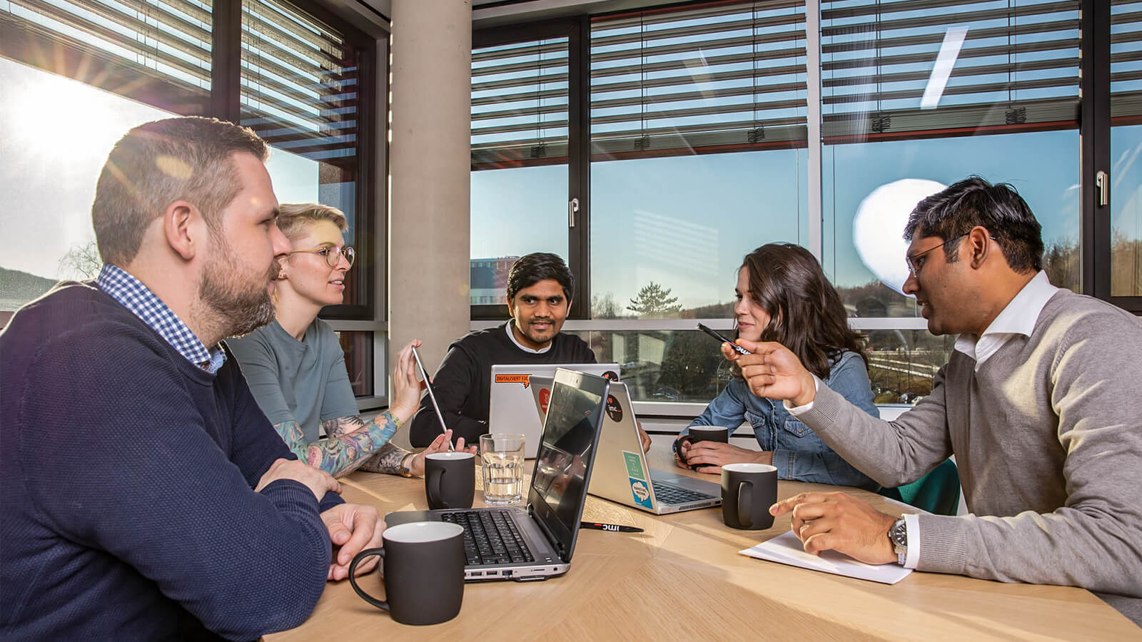 people having a discussion around table