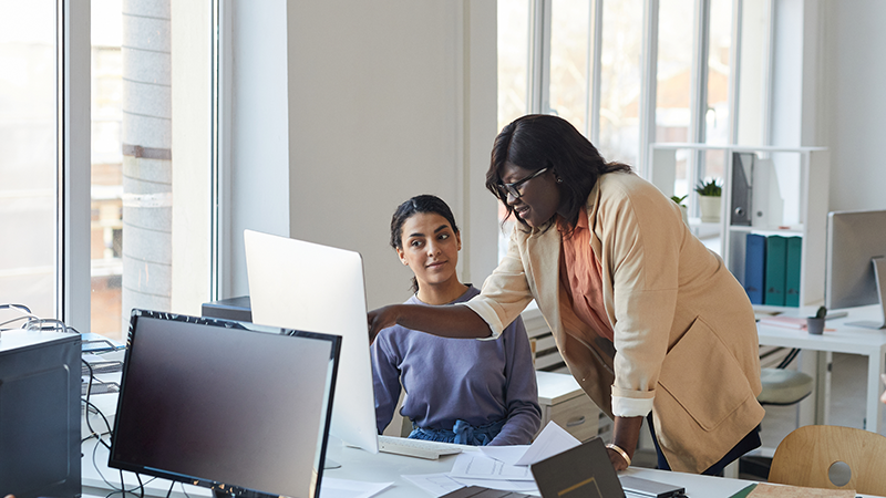 helpful person explaining technology to colleague