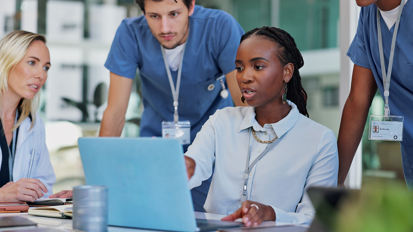 medical professionals learning from a digital device