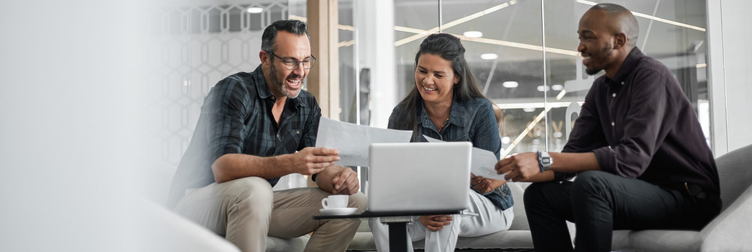 Three learners with a laptop