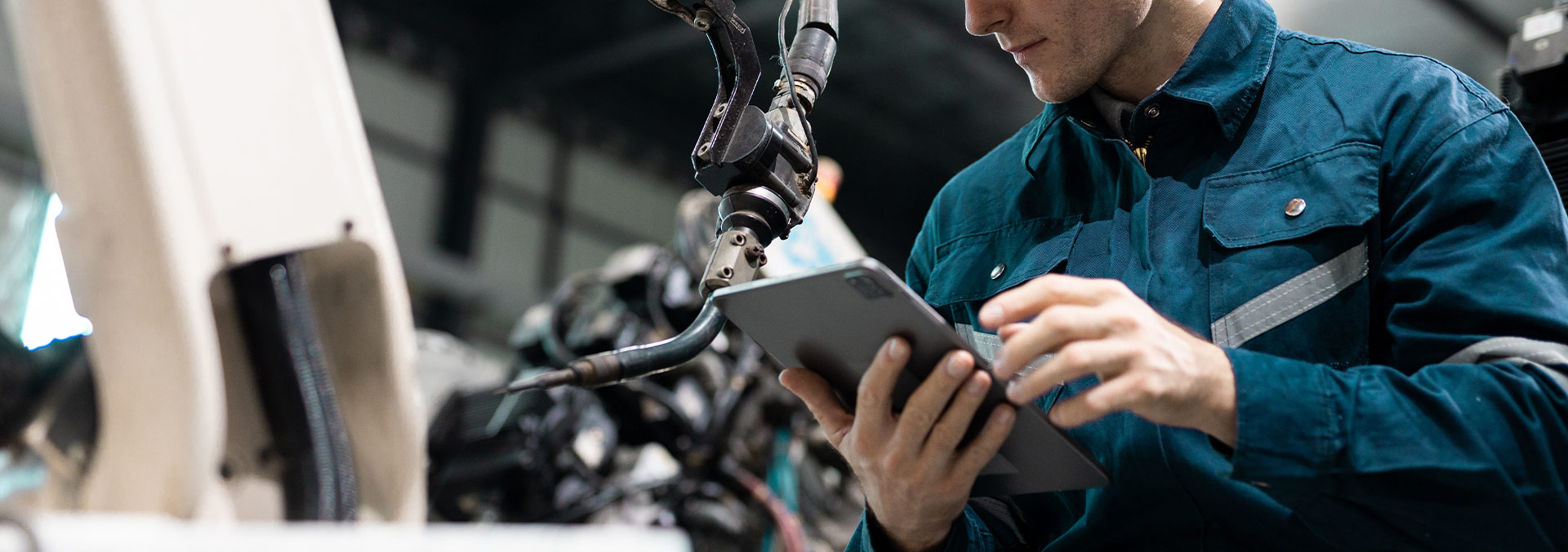 Manufacturing worker working with an automated robot
